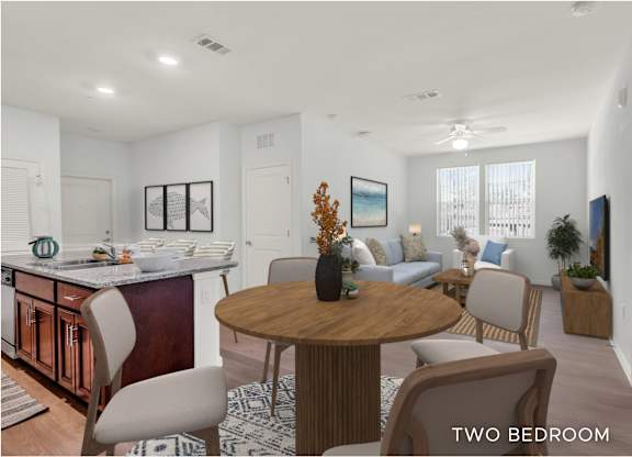 A modern two bedroom apartment with a kitchen, dining area and living room.