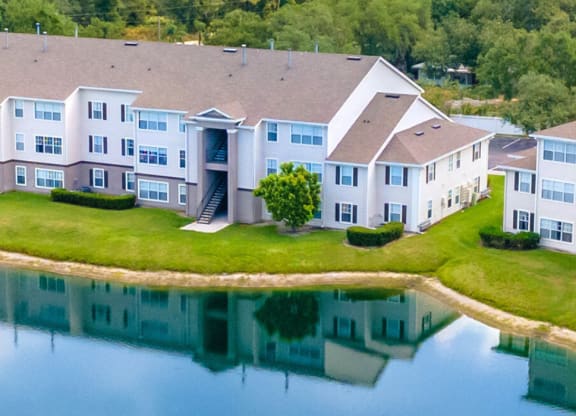 an aerial view of a large apartment complex next to a lake