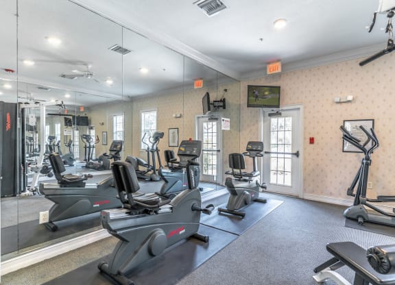 fitness center with equipment and mirror