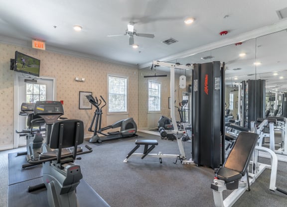 fitness center with equipment and mirror
