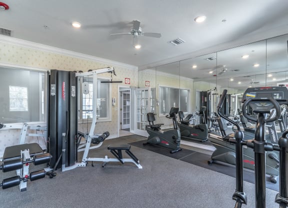 fitness center with equipment and mirror
