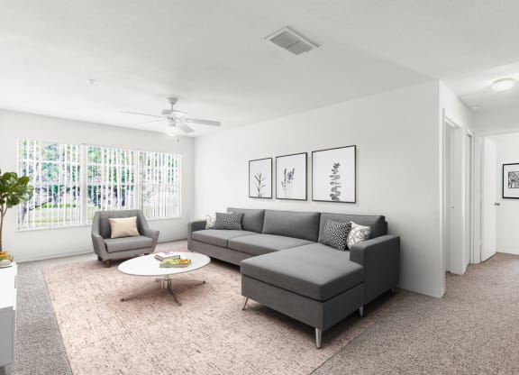 a living room with a couch coffee table and a ceiling fan