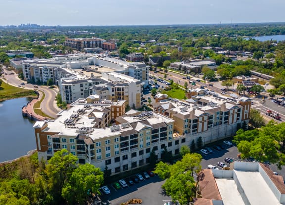 an aerial view of a large building next to a body of water