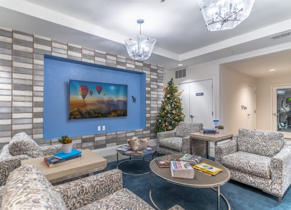 a living room with a christmas tree and couches