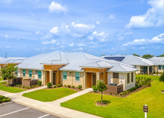 a row of houses with solar panels on the roof