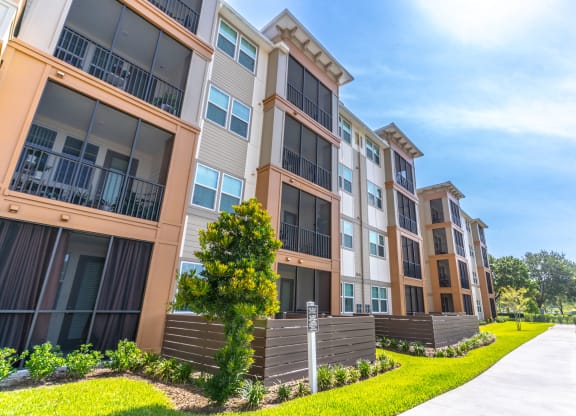 an exterior view of an apartment building on a sunny day