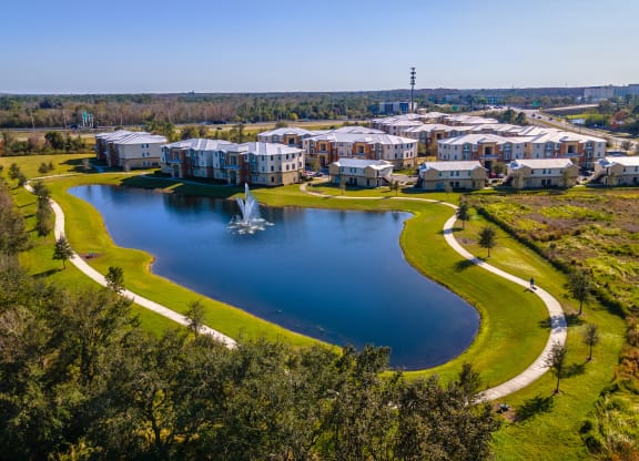 an aerial view of houses next to a lake