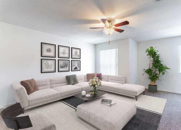 a living room with white walls and a ceiling fan