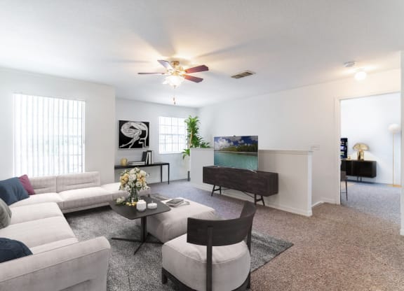 a living room with white couches and a coffee table