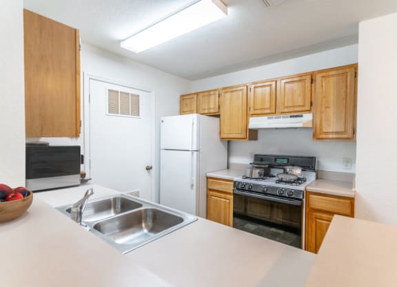 a kitchen with wooden cabinets and white appliances