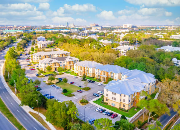 an aerial view of a neighborhood with cars parked on the side of the road