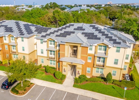 an aerial view of an apartment complex with solar panels on the roof