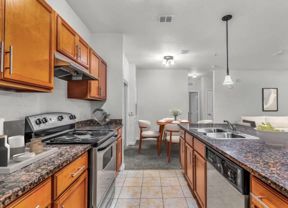 a kitchen with wooden cabinets and granite countertops