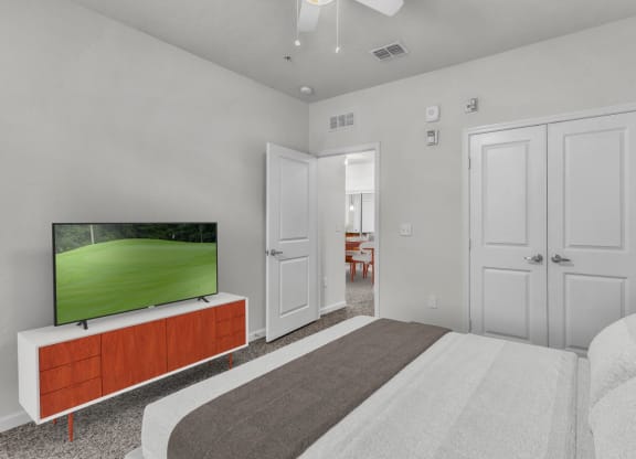 a bedroom with a bed and a tv