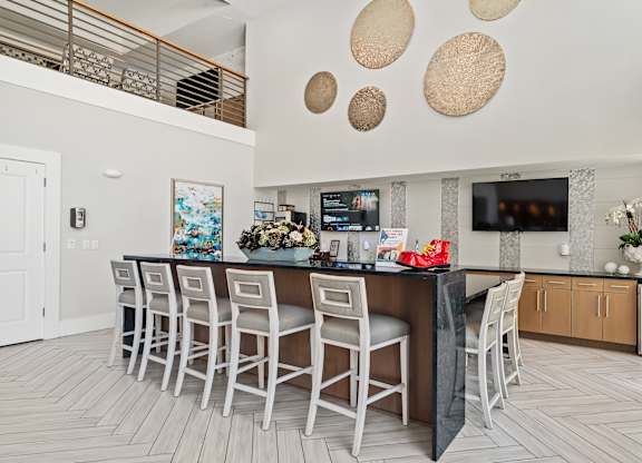 A modern kitchen with a bar area and a dining table.