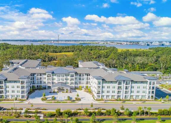 A large, modern building complex with multiple wings and a spacious courtyard in the center.