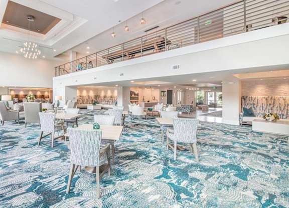 A spacious dining area with a carpeted floor and white chairs.
