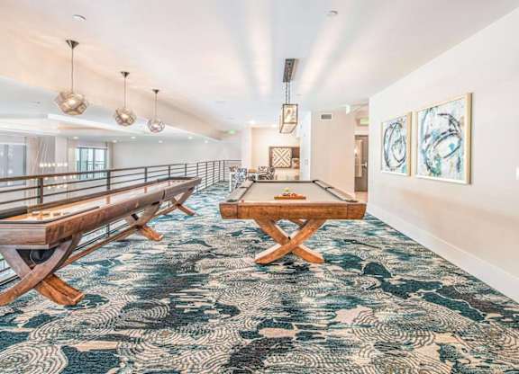 A room with a long wooden bench and a table with chairs.