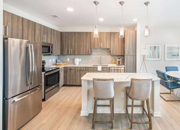 A modern kitchen with a dining area.
