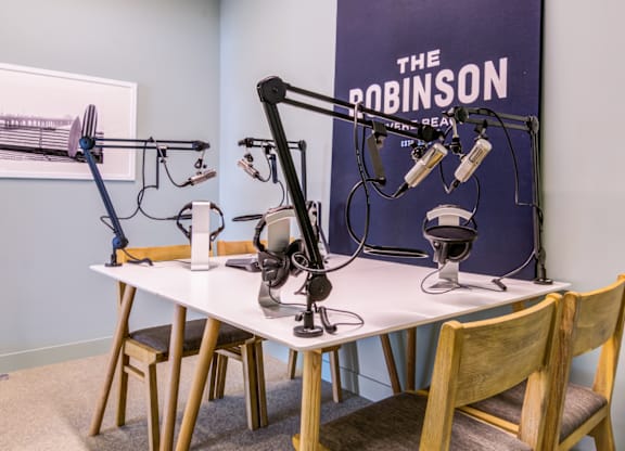 A studio setup with a microphone and headphones on a table.