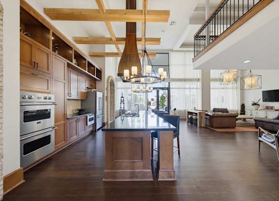 A modern kitchen with wooden cabinets and a large island.