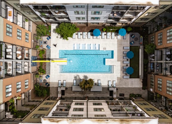 an aerial view of a swimming pool in the middle of a building