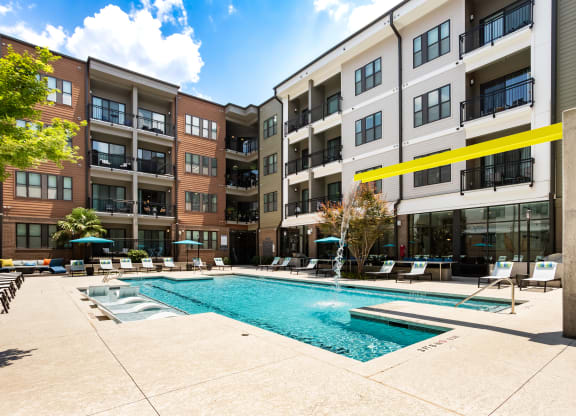 a swimming pool in front of an apartment building