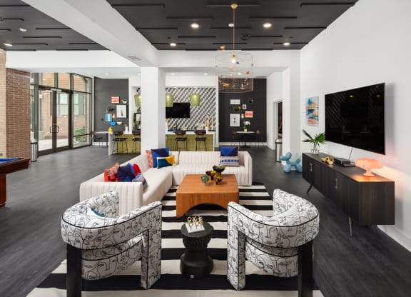 a living room with couches and a table and a television