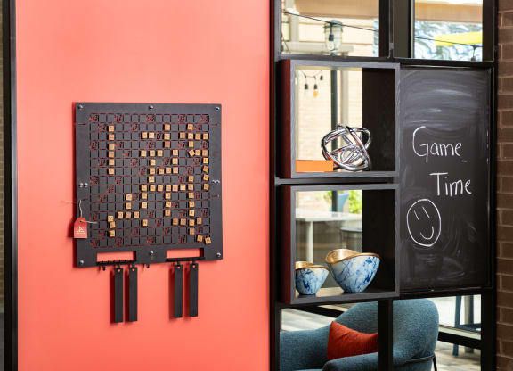 a wall with a piece of art on it next to a window