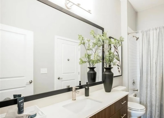 Spacious bathroom with contemporary fixtures, single-sink vanity, and neutral-toned design