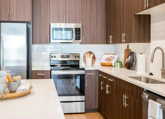 Fully Equipped Kitchen with Quartz Countertops and Stainless Steel Finishes