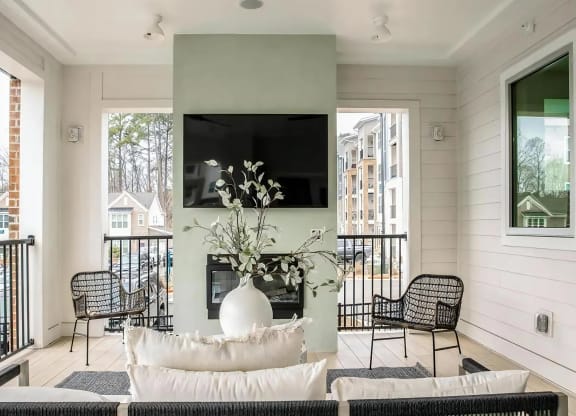 Balcony off Clubhouse with a large TV and seating