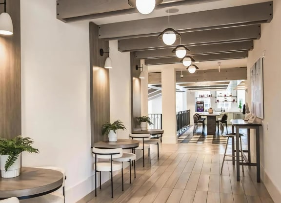 Community Loft Space Featuring Built-In Tables, Cozy Chairs & Coffee Bar Access