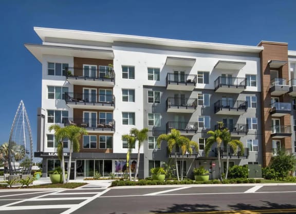 Anchor Riverwalk Building Exterior with Modern Balconies, Palm Trees, and Leasing Office