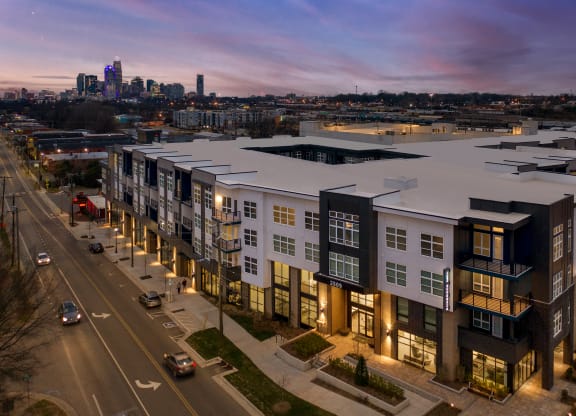 an aerial view of an apartment complex with a city in the background