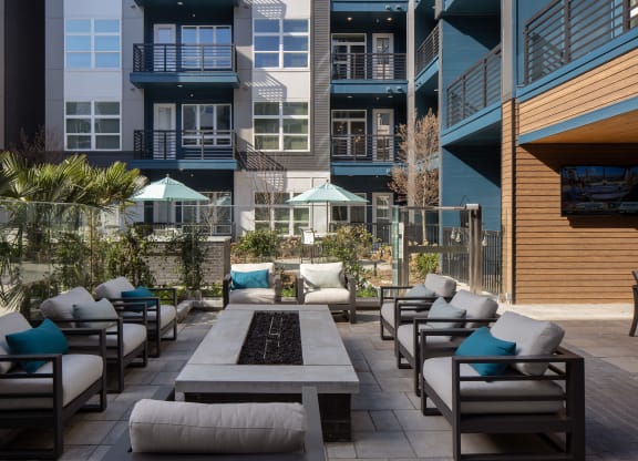 an outdoor patio with chairs and tables and buildings
