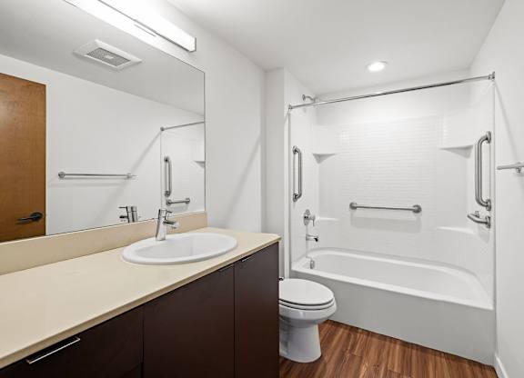 A white bathroom with a sink, toilet, and bathtub.