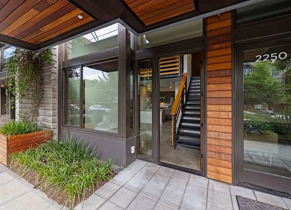 A modern building with a wooden facade and a glass door.