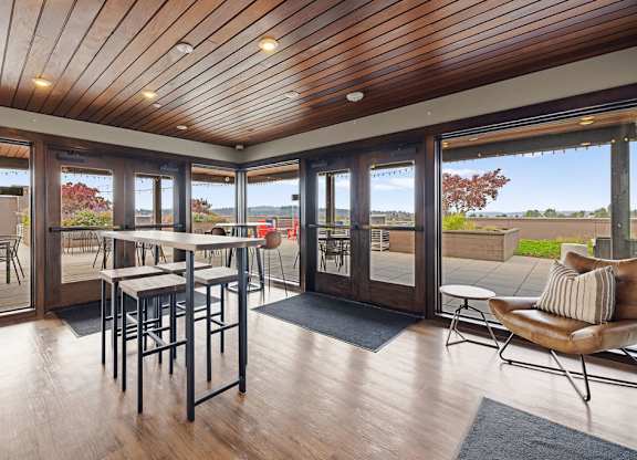 A wooden table with chairs is in a room with a wooden ceiling and floor.