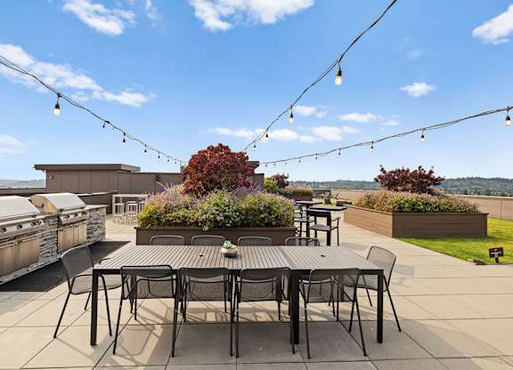 A patio with a table and chairs is set up for an outdoor gathering.