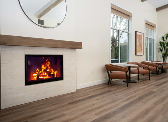 a living room with a fireplace and a group of chairs