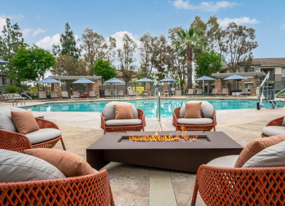 a swimming pool with chairs and a coffee table