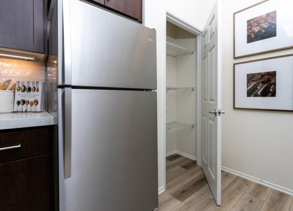 a kitchen with a refrigerator and a walk in closet