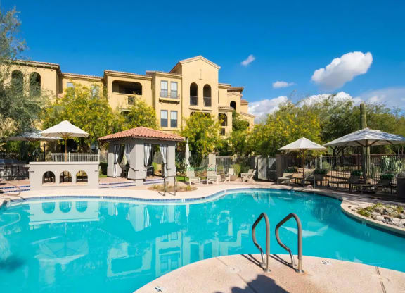 Apartments for Rent in North Scottsdale AZ - Desert Parks Vista - Resort-Style Swimming Pool with Tile Details, Covered Cabanas, Umbrellas, Lounge Poolside Chairs, and Seating Area