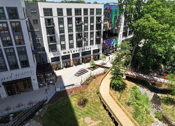A view of a city area with a bridge over a stream.