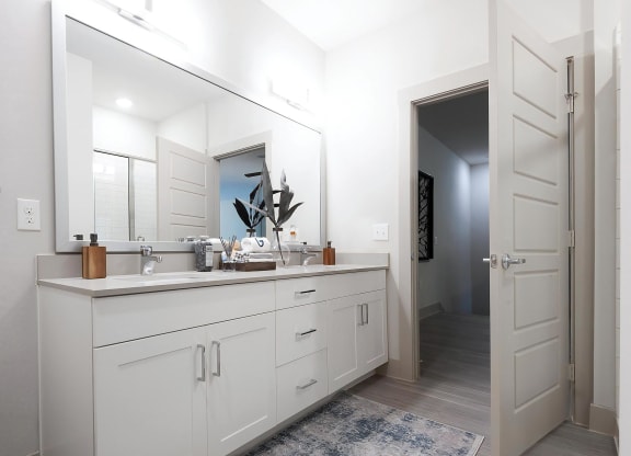 Modern Bathroom Featuring Double Vanity and Glass-Enclosed Shower