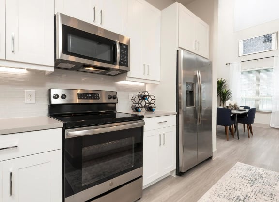 Fully-Equipped Kitchen with Stainless Steel Appliances and Bright Finishes