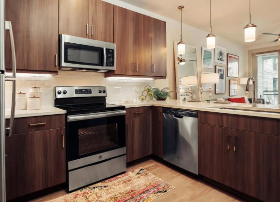 Contemporary Kitchen Featuring Quartz Countertops and Dark Cabinetry