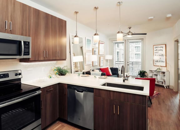 Open-Concept Layout with Kitchen, Living Area, and Access to Patio