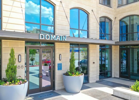 Leasing Office Entry at Domain at The Gate with Arched Windows and Modern Planters